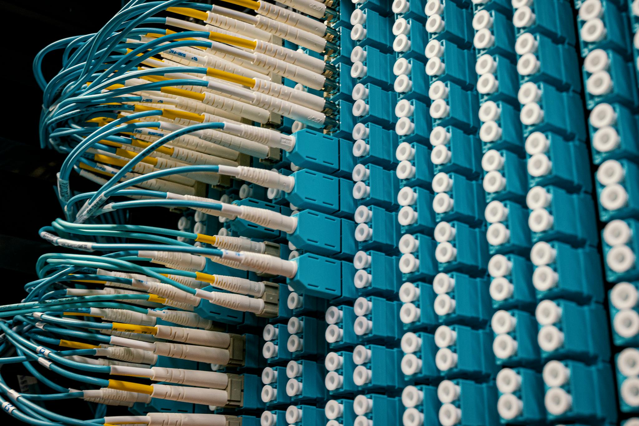 From below of fiber optic equipment with similar colorful rubber cables and round sockets